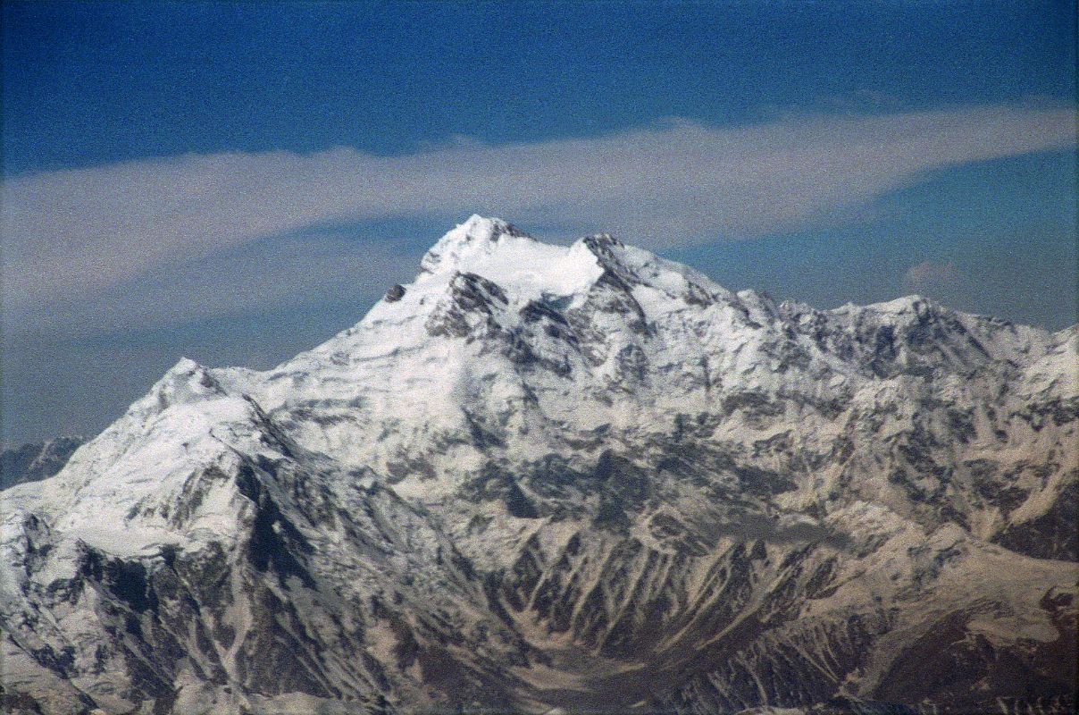 10 Nanga Parbat Rakhiot Face, Rakhiot Peak, Silver Saddle, East Peak, Silver Plateau, Summit, North Peaks On Flight From Islamabad To Skardu On the 40-minute flight from Islamabad to Skardu, the captain announces, We'll be flying at a planned altitude of 8,000 metres. Perfect I thought, we'll be exactly at the height of Nanga Parbat. The flight starts low key with the stewardesses serving drinks while we bide our time. When the pilot announces Nanga Parbat is immediately ahead on the right, all hell breaks loose. As one, all the tourists, including me, are up in the aisles, craning their necks, running for the cockpit. The sounds of cameras are everywhere. There it is, within arms reach. Nanga Parbat in perfect early morning splendor! After passing by the Diamir Face, we can see Hermann Buhls route of first ascent with the Rakhiot Peak leading up to the Silver Saddle between the Nanga Parbat Southeast and East Peaks, and up to the summit with the North Peaks on the right.